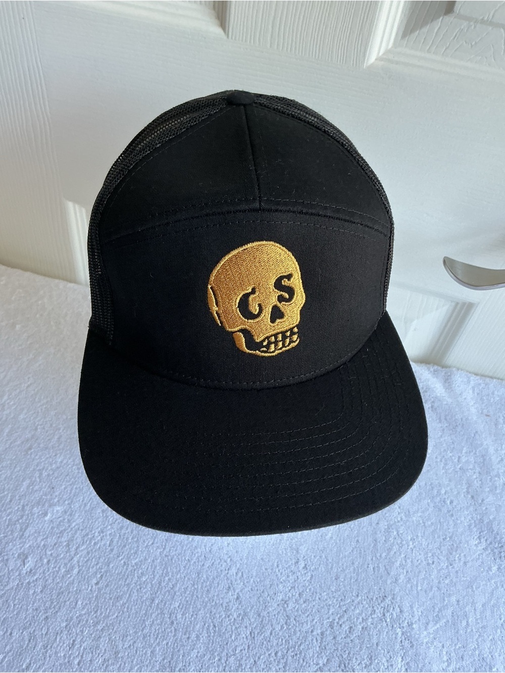 Black Trucker Hat with Gold Skull Embroidery